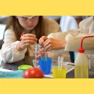 children in lab coats in a science lab